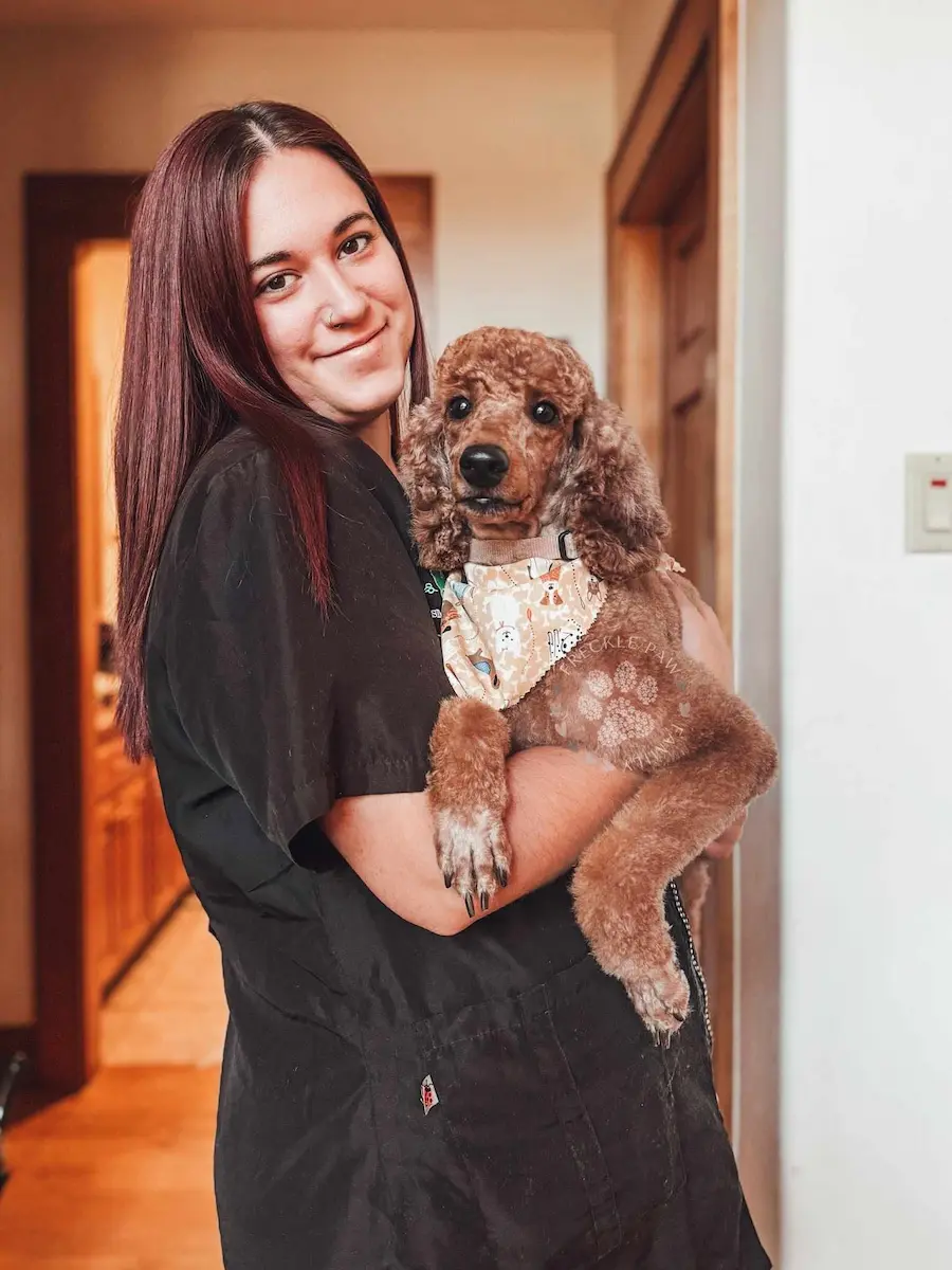 Gabrielle holding a freshly groomed dog