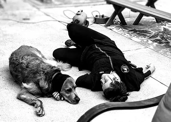 Gabby calmly spending time on the floor with a dog